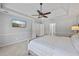 Spacious main bedroom features a ceiling fan, tv, neutral colors and plush carpet at 2500 Ashbourne Dr, Lawrenceville, GA 30043