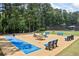 Well-maintained recreation area features shuffleboard, seating, and wooded scenery at 2500 Ashbourne Dr, Lawrenceville, GA 30043
