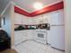 Well-lit kitchen featuring white cabinetry and modern appliances at 300 Peachtree Ne St # 11C, Atlanta, GA 30308