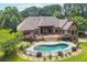 Expansive backyard featuring an in-ground pool, deck, and mature landscaping at 3505 Watson Rd, Cumming, GA 30028