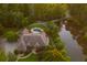 Expansive home featuring a private pool and pond nestled amongst lush greenery, providing a secluded retreat at 3505 Watson Rd, Cumming, GA 30028
