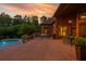 Outdoor deck boasts ample seating, views of the pool, and lovely brick exterior, perfect for entertaining guests at 3505 Watson Rd, Cumming, GA 30028