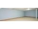 Unfinished basement with painted walls and ceiling with exposed wood trim and concrete floors at 3505 Watson Rd, Cumming, GA 30028