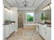 Bright bathroom featuring double sinks, quartz countertops, travertine floors, and a separate shower and tub at 3505 Watson Rd, Cumming, GA 30028