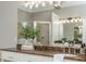 A bathroom vanity features a dark countertop with double sinks and a large, well-lit mirror at 3505 Watson Rd, Cumming, GA 30028