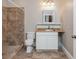 Functional bathroom featuring a tiled shower and toilet, and a vanity with a white cabinet at 3505 Watson Rd, Cumming, GA 30028