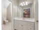 Clean bathroom featuring a toilet and a white vanity with a large mirror and decorative lighting at 3505 Watson Rd, Cumming, GA 30028
