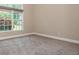 A simple, carpeted bedroom with a large, arched window provides plenty of natural light at 3505 Watson Rd, Cumming, GA 30028