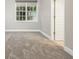 A room featuring soft carpeting, a window, and a white door at 3505 Watson Rd, Cumming, GA 30028