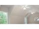 Bright bedroom with high ceilings, two ceiling fans, and a large window overlooking a green space at 3505 Watson Rd, Cumming, GA 30028