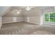 Spacious bonus room featuring wall-to-wall carpet, high ceilings and large windows at 3505 Watson Rd, Cumming, GA 30028
