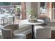 Cozy breakfast nook with marble table, comfortable seating, and views of the outdoor deck at 3505 Watson Rd, Cumming, GA 30028