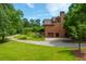 Lovely home exterior with a charming brick facade, lush landscaping, and convenient garage access at 3505 Watson Rd, Cumming, GA 30028