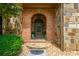 Inviting brick arched entryway with stone accents and glass paneled front door at 3505 Watson Rd, Cumming, GA 30028