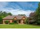 Beautiful single-story brick home with lush green lawn and mature trees at 3505 Watson Rd, Cumming, GA 30028