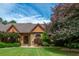 Attractive brick home with arched entryway, well-manicured lawn, and mature trees at 3505 Watson Rd, Cumming, GA 30028
