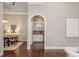 Arched doorway view into dining room and bar area, with hardwood floors and neutral paint at 3505 Watson Rd, Cumming, GA 30028