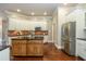 Modern kitchen boasts a stainless steel refrigerator, custom cabinetry, and stone countertops at 3505 Watson Rd, Cumming, GA 30028