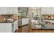 Well-lit kitchen with stone countertops, stainless appliances, and view to the dining area at 3505 Watson Rd, Cumming, GA 30028