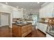 Bright kitchen features white cabinetry, a center wooden island, and stainless appliances at 3505 Watson Rd, Cumming, GA 30028
