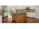 Kitchen features wooden cabinets, a center island with sink, and a view of the dining area at 3505 Watson Rd, Cumming, GA 30028