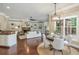 Spacious living room flowing into dining area, with built-in shelves and outdoor views at 3505 Watson Rd, Cumming, GA 30028