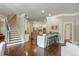 Open-concept living room with hardwood floors leading to the kitchen and staircase with iron railing at 3505 Watson Rd, Cumming, GA 30028