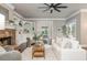 Inviting living room featuring a stone fireplace, built-in shelves, large windows, and a neutral color palette at 3505 Watson Rd, Cumming, GA 30028
