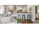 Inviting living room area features a fireplace, staircase, and bar seating leading to the kitchen at 3505 Watson Rd, Cumming, GA 30028