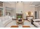 Elegant living room featuring a stone fireplace, modern furniture, and bright, open space at 3505 Watson Rd, Cumming, GA 30028