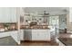 Spacious living area with built-in shelving, a stone fireplace, and an open view to the kitchen at 3505 Watson Rd, Cumming, GA 30028