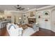 Comfortable living room featuring a stone fireplace, hardwood floors, and custom built-in shelving at 3505 Watson Rd, Cumming, GA 30028