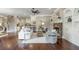 Open concept living room with hardwood floors, stone fireplace, and seamless flow to kitchen and staircase at 3505 Watson Rd, Cumming, GA 30028