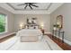 Main bedroom featuring a tray ceiling, fan, a large window, and neutral decor at 3505 Watson Rd, Cumming, GA 30028