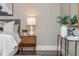 Main bedroom features a hardwood floor, bedside table with a lamp, and neutral decor at 3505 Watson Rd, Cumming, GA 30028