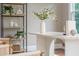 Bright office shows shelving decor with greenery and decor items, a desk and two lounge chairs at 3505 Watson Rd, Cumming, GA 30028