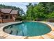 Stunning inground kidney-shaped pool with natural stone border, built-in steps, and lush landscaping at 3505 Watson Rd, Cumming, GA 30028