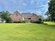 Charming brick home featuring a beautifully landscaped front yard with lush green grass at 3580 Canon Creek Dr, Cumming, GA 30041