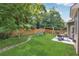Spacious backyard with a grassy lawn, a play set, and a patio with outdoor seating at 6202 Oakdale Ridge Se Ct, Mableton, GA 30126