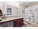 Bathroom featuring wood-look vinyl flooring, a granite countertop, and a shower with a floral curtain at 6202 Oakdale Ridge Se Ct, Mableton, GA 30126