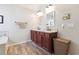 Bright bathroom with double sinks set in granite countertops and wood cabinetry at 6202 Oakdale Ridge Se Ct, Mableton, GA 30126