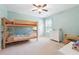 Bedroom features a bunk bed, natural light from the window, and neutral-colored walls and carpet at 6202 Oakdale Ridge Se Ct, Mableton, GA 30126