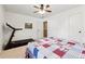 Neutral bedroom featuring a treadmill, ceiling fan, and large window providing ample natural light at 6202 Oakdale Ridge Se Ct, Mableton, GA 30126