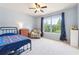 Bedroom features a large window, soft carpet, and neutral-colored walls, creating a cozy and inviting space at 6202 Oakdale Ridge Se Ct, Mableton, GA 30126