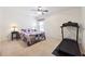 Bedroom featuring a bed, treadmill, and natural light, creating a functional living space at 6202 Oakdale Ridge Se Ct, Mableton, GA 30126