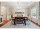 Well-lit dining room featuring stylish decor, a wooden dining set, and a decorative area rug over hardwood floors at 6202 Oakdale Ridge Se Ct, Mableton, GA 30126