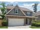 Charming two-story home with a brick and siding exterior, two-car garage, and a well-manicured lawn at 6202 Oakdale Ridge Se Ct, Mableton, GA 30126