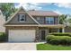Charming two-story home featuring a stone facade, neutral siding, covered entryway, and an attached two car garage at 6202 Oakdale Ridge Se Ct, Mableton, GA 30126