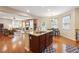 Open kitchen with an island featuring a sink and seating and views to the living room at 6202 Oakdale Ridge Se Ct, Mableton, GA 30126