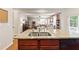 Spacious kitchen featuring a central island, granite countertops, stainless steel sink, and an open view to the living area at 6202 Oakdale Ridge Se Ct, Mableton, GA 30126